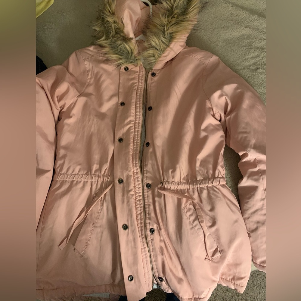 Winter coat with faux fur on the hood and wool lining inside.